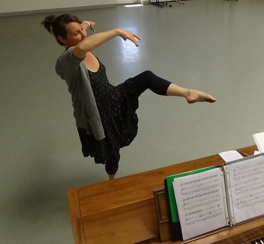 Romy dancing by piano